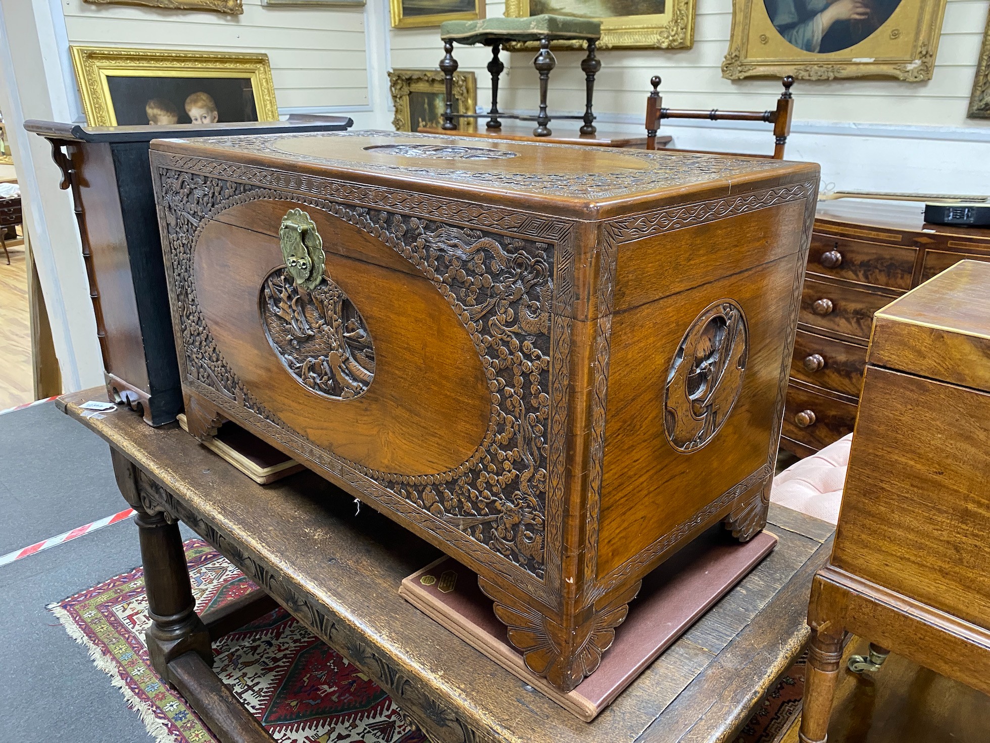 A carved Chinese camphor wood coffer, length 104cm, depth 52cm, height 63cm